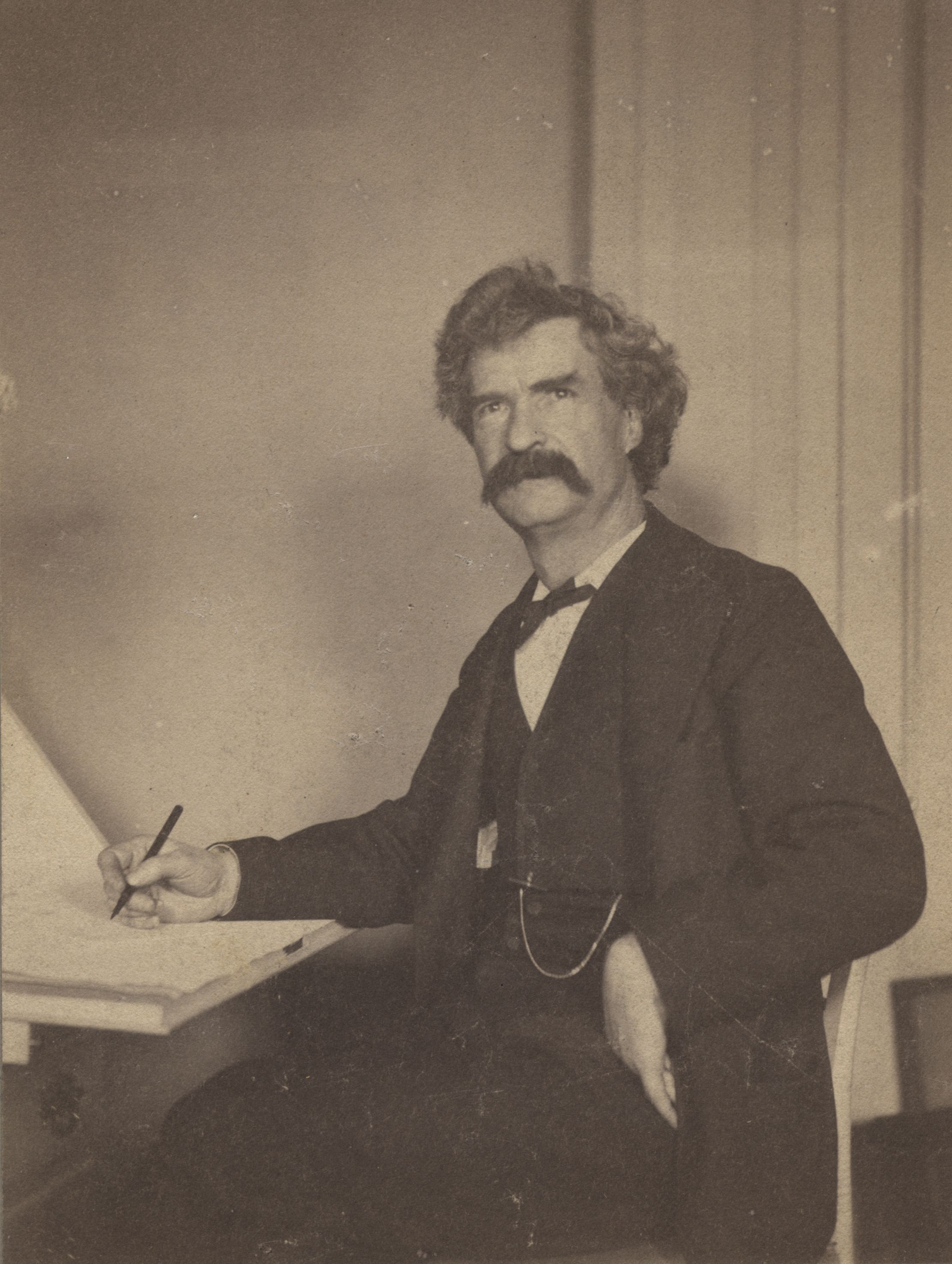 Samuel L. Clemens at writing desk